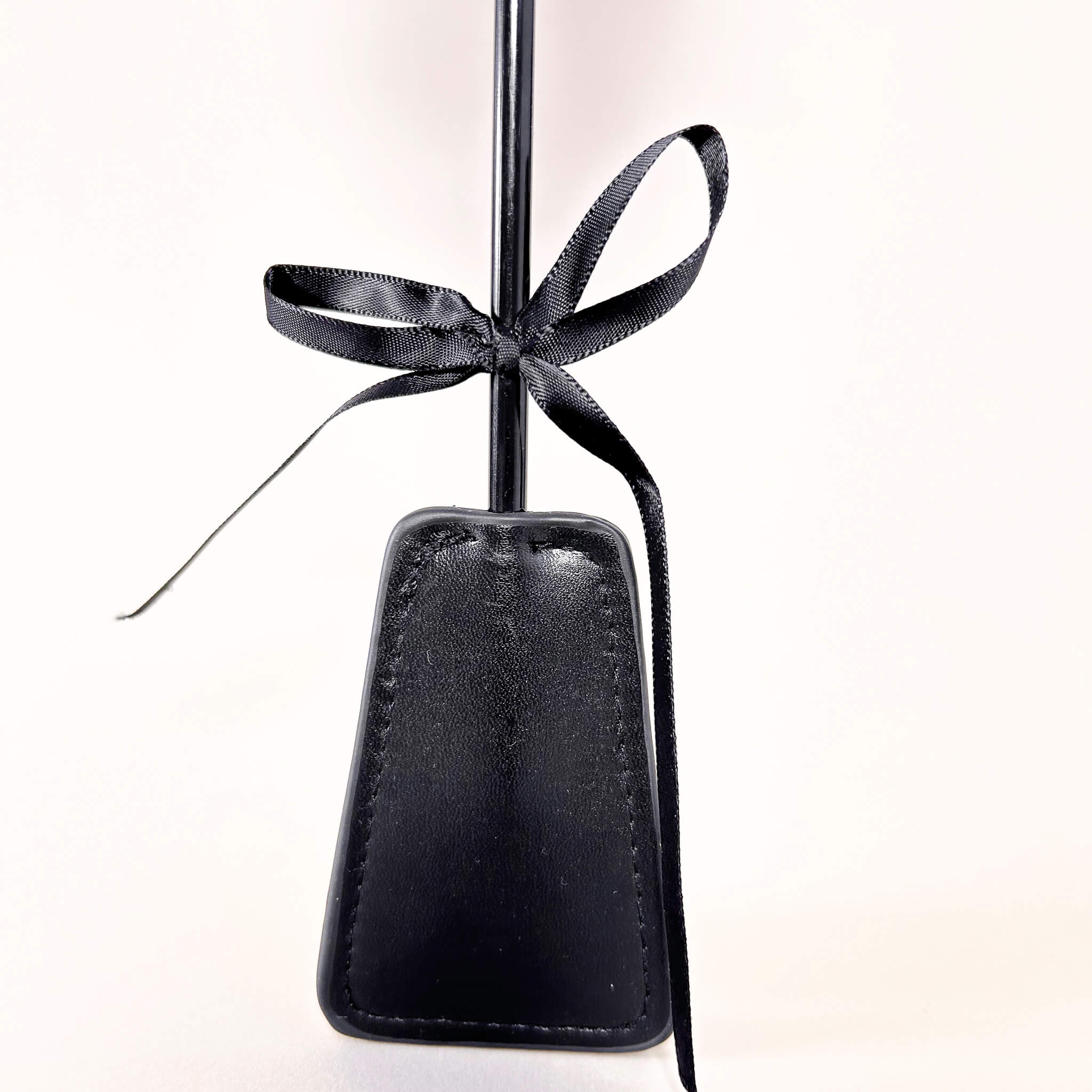 Black flogger crop with a black ribbon on a white background