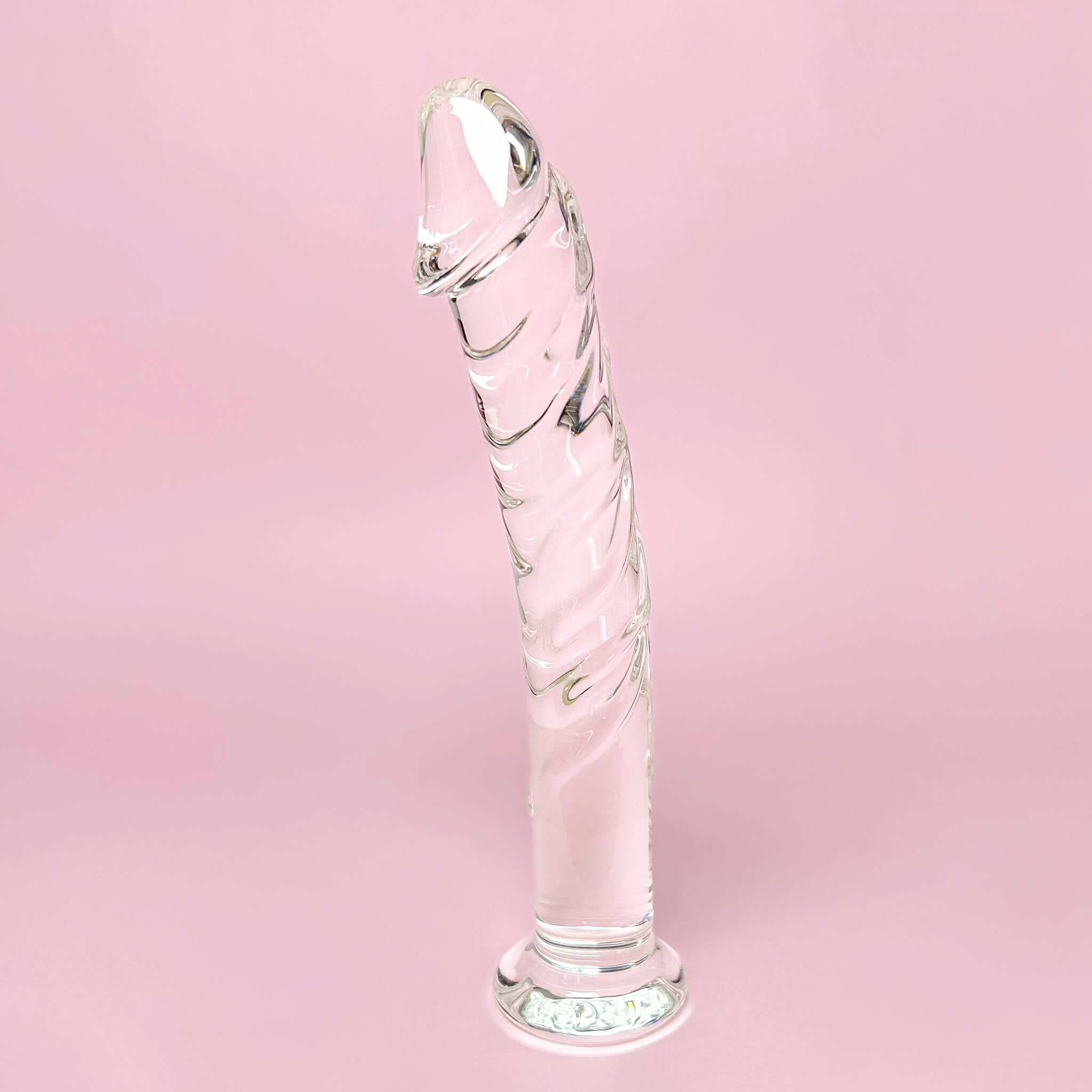 Curved Glass Dildo with Veins on a pink background