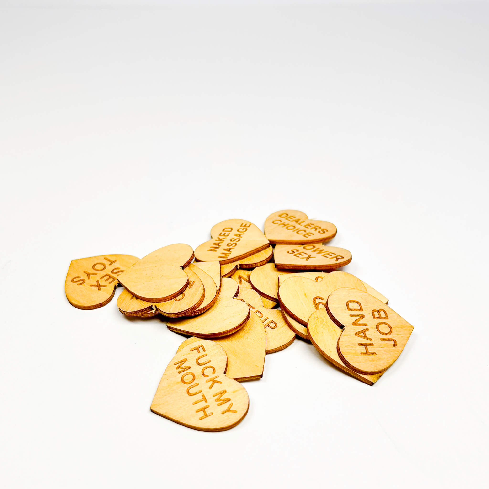 Wood heart-shaped sex tokens with various inscriptions on a white background