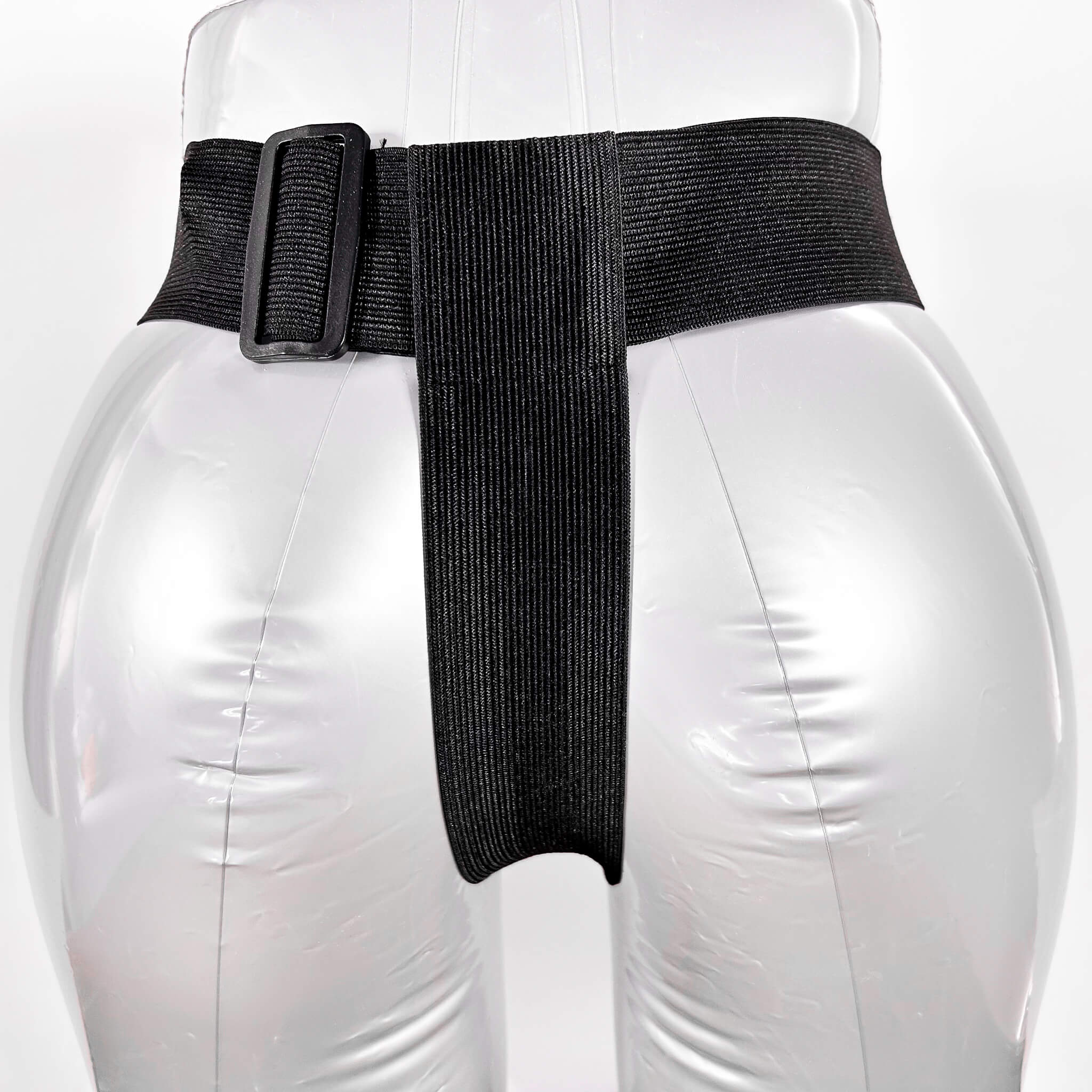 Black belt harness with a buckle on a white background