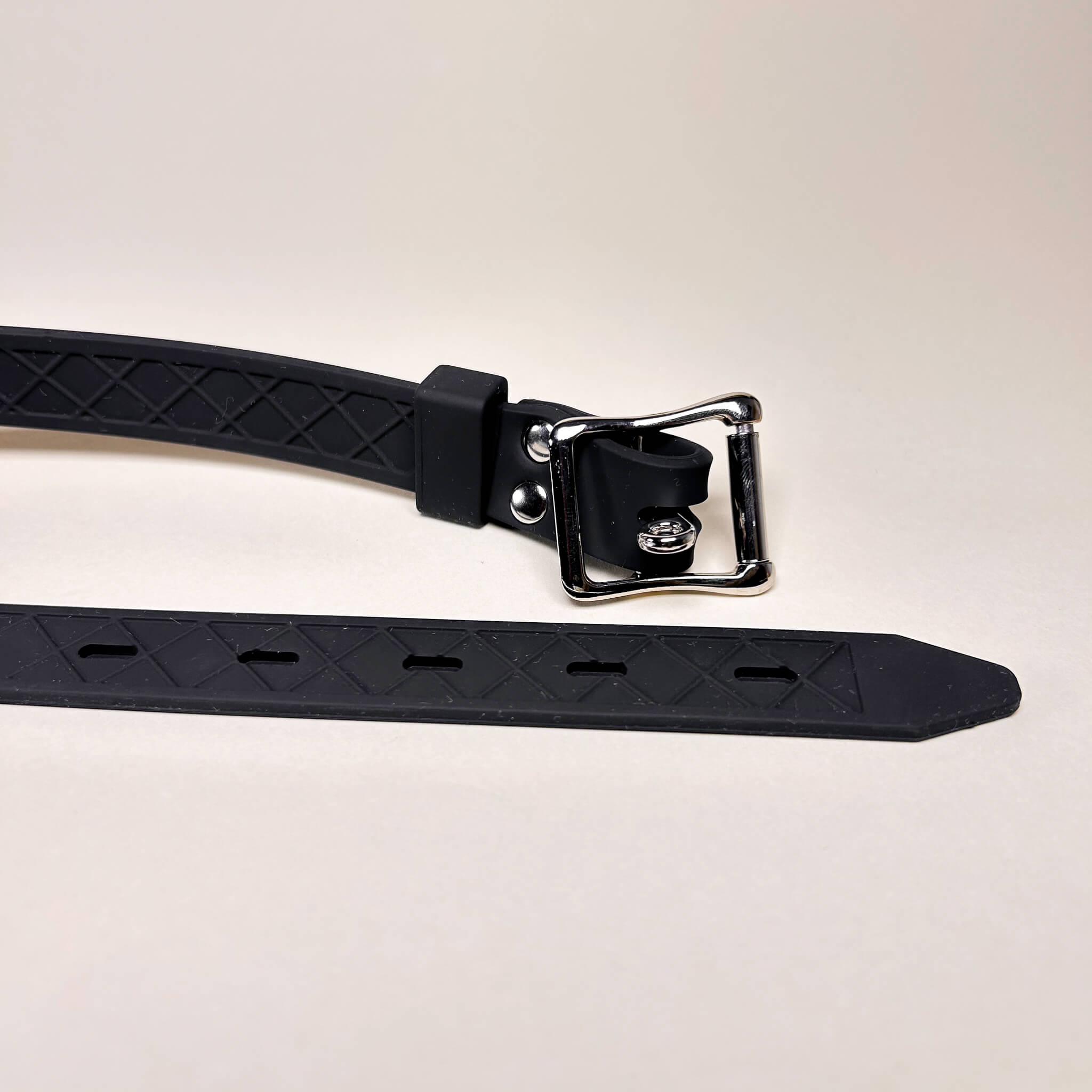 Double Dildo Gag with metal buckle on a light gray background