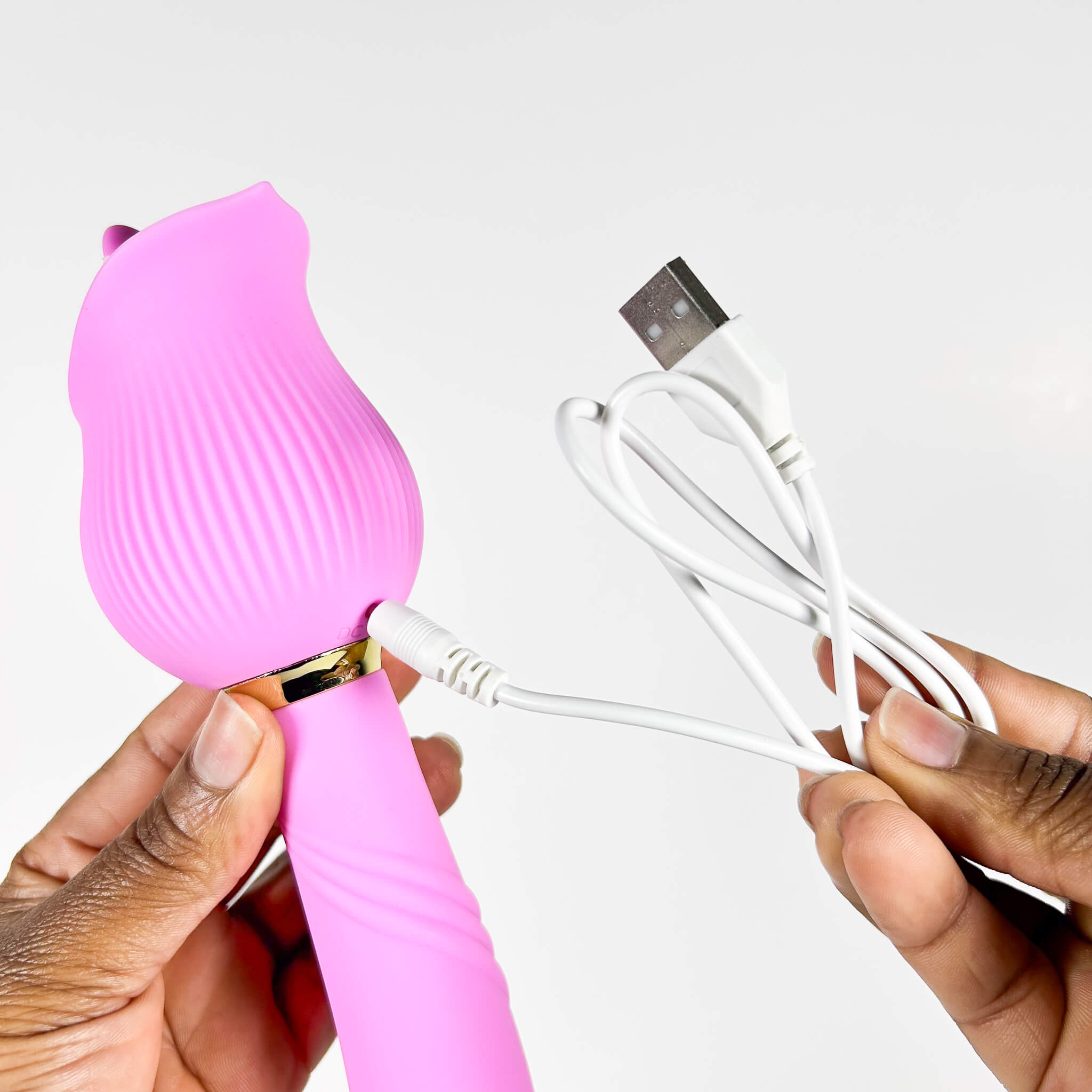 Pink silicone Double Vibrator with USB cable on a white background