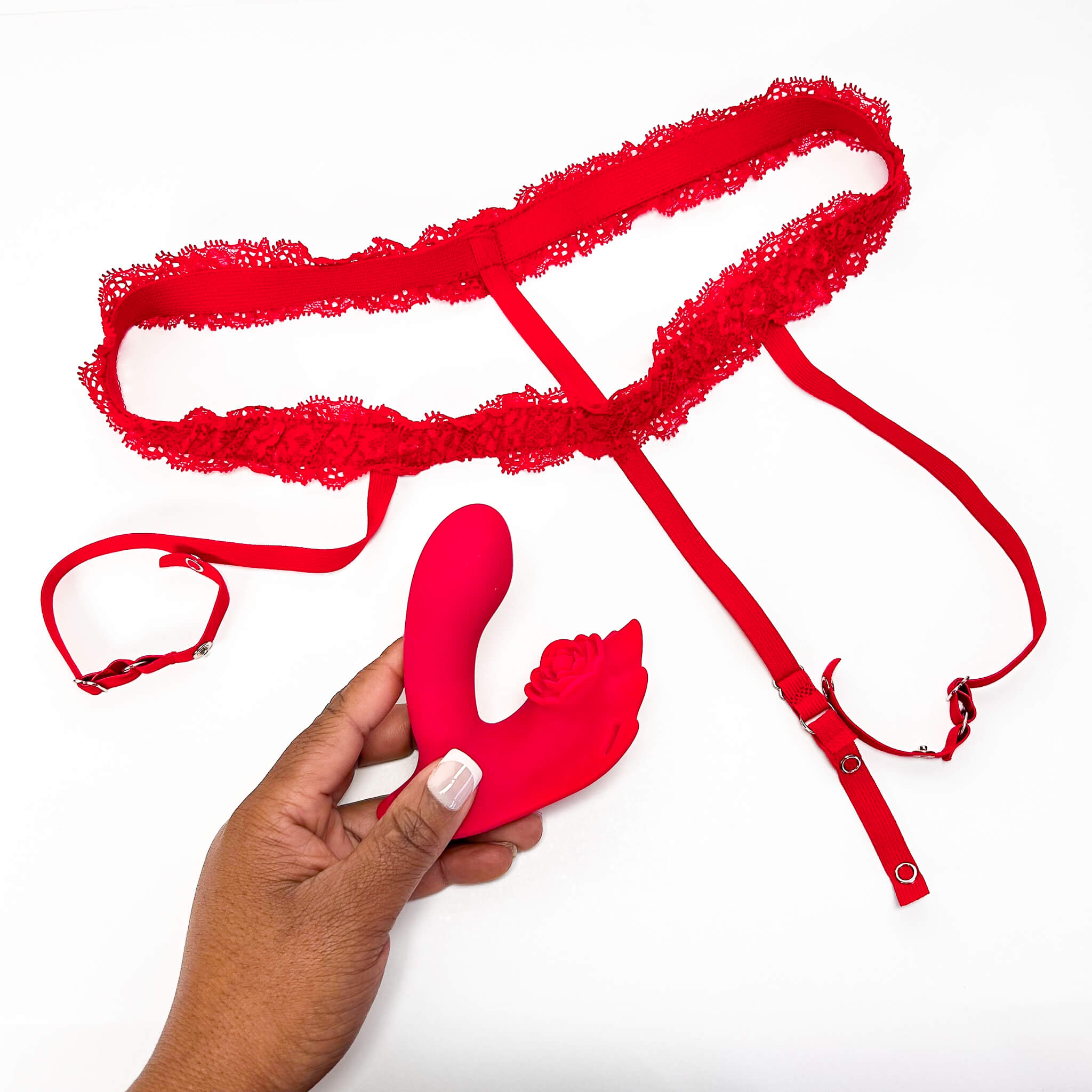 Red lace panties with a hand holding a red silicone Insertable App Controlled Panty Vibrator on a white background
