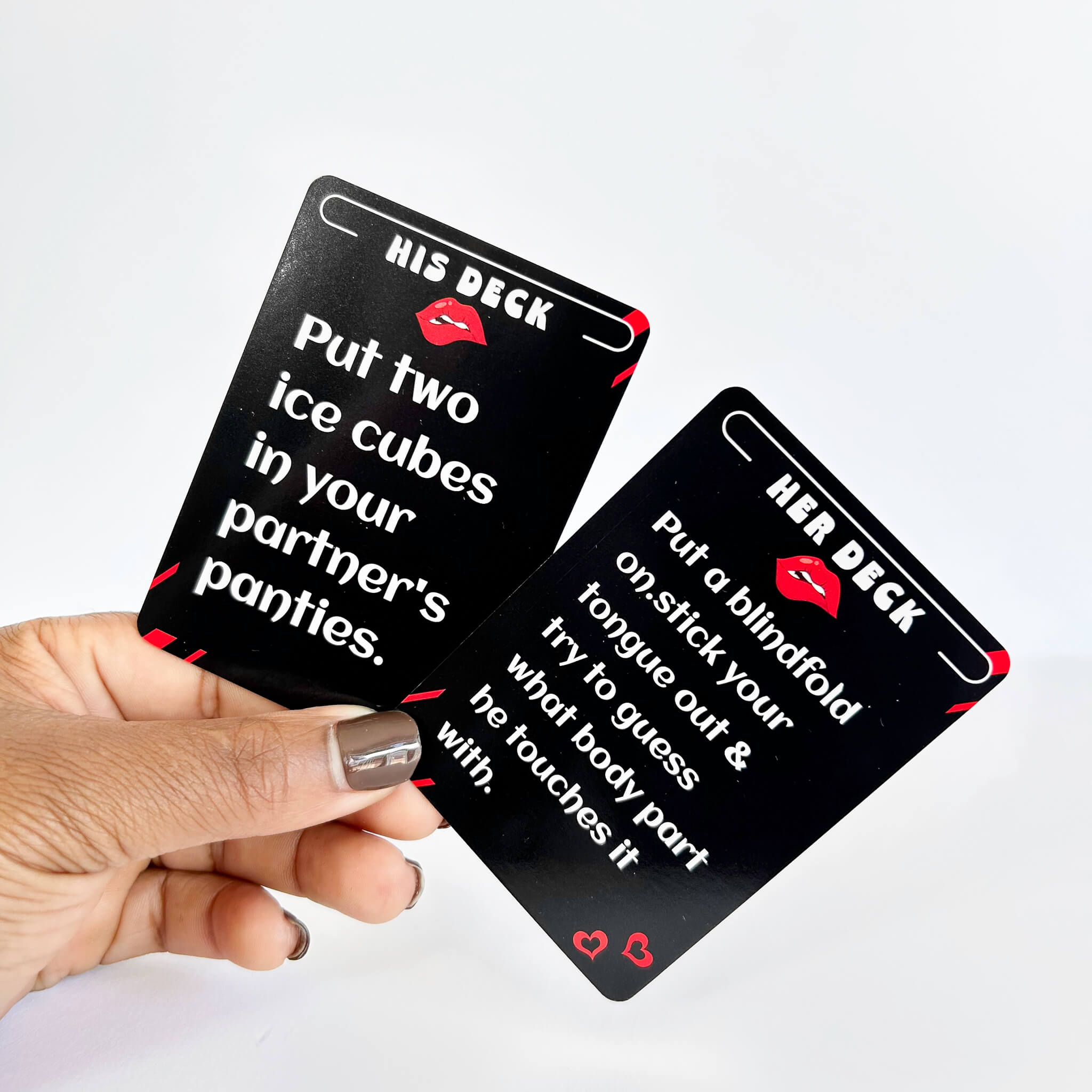 Two black cards labeled 'His Deck' and 'Her Deck' held by a hand on a white background.