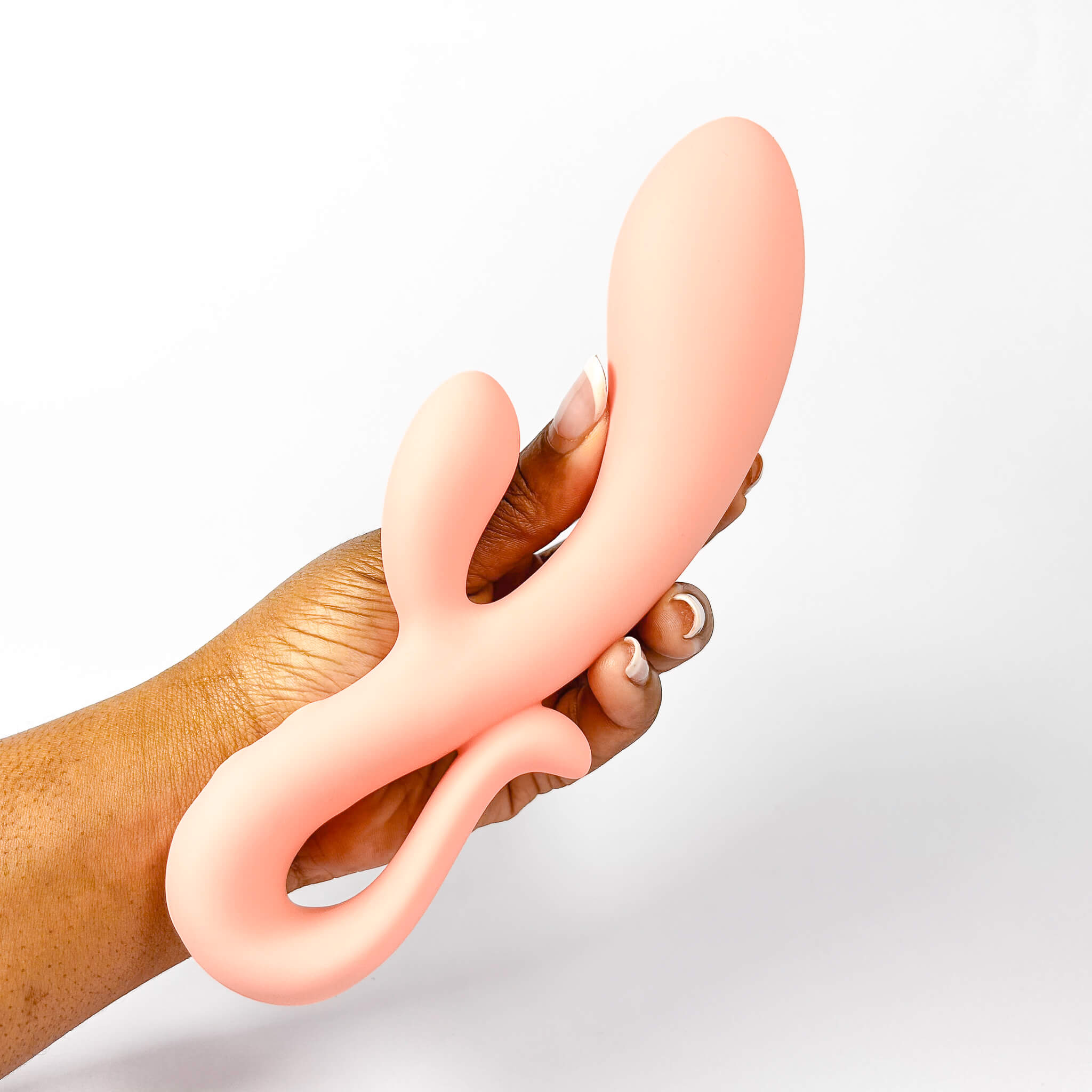 Hand holding a Peach Sweet Vibe Naughty Rabbit Vibrator against a light gray background