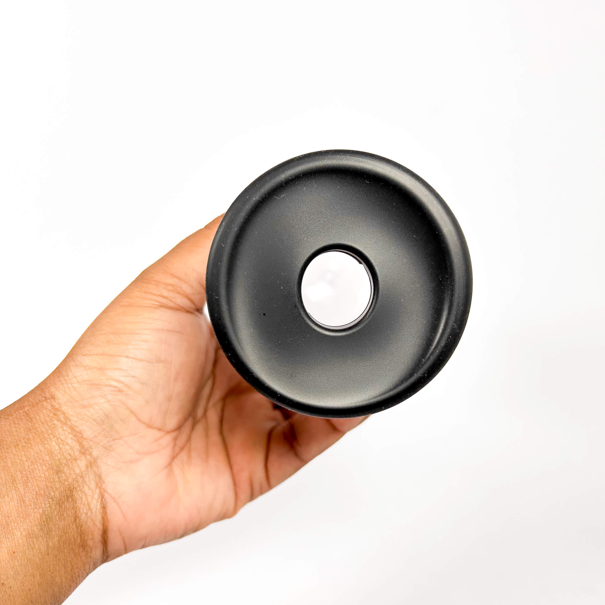 Hand holding a Power Up Pistol Penis Pump on a white background