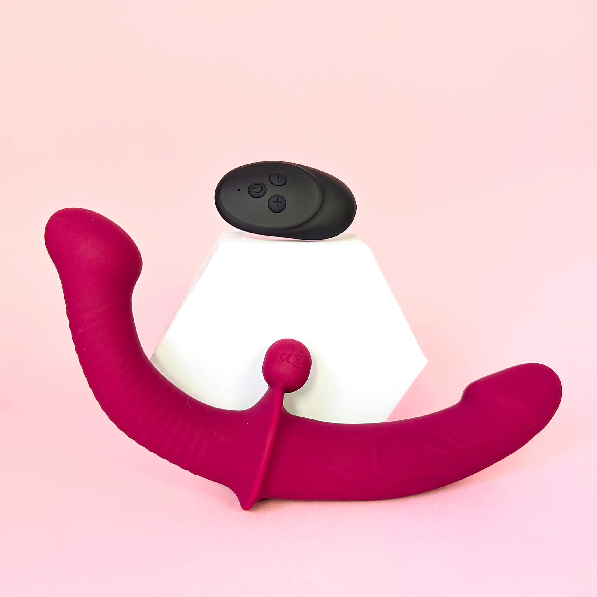 Remote Double Ended Dildo Vibrator With Clit Stimulator Ball with a pink body and white base on a pink background
