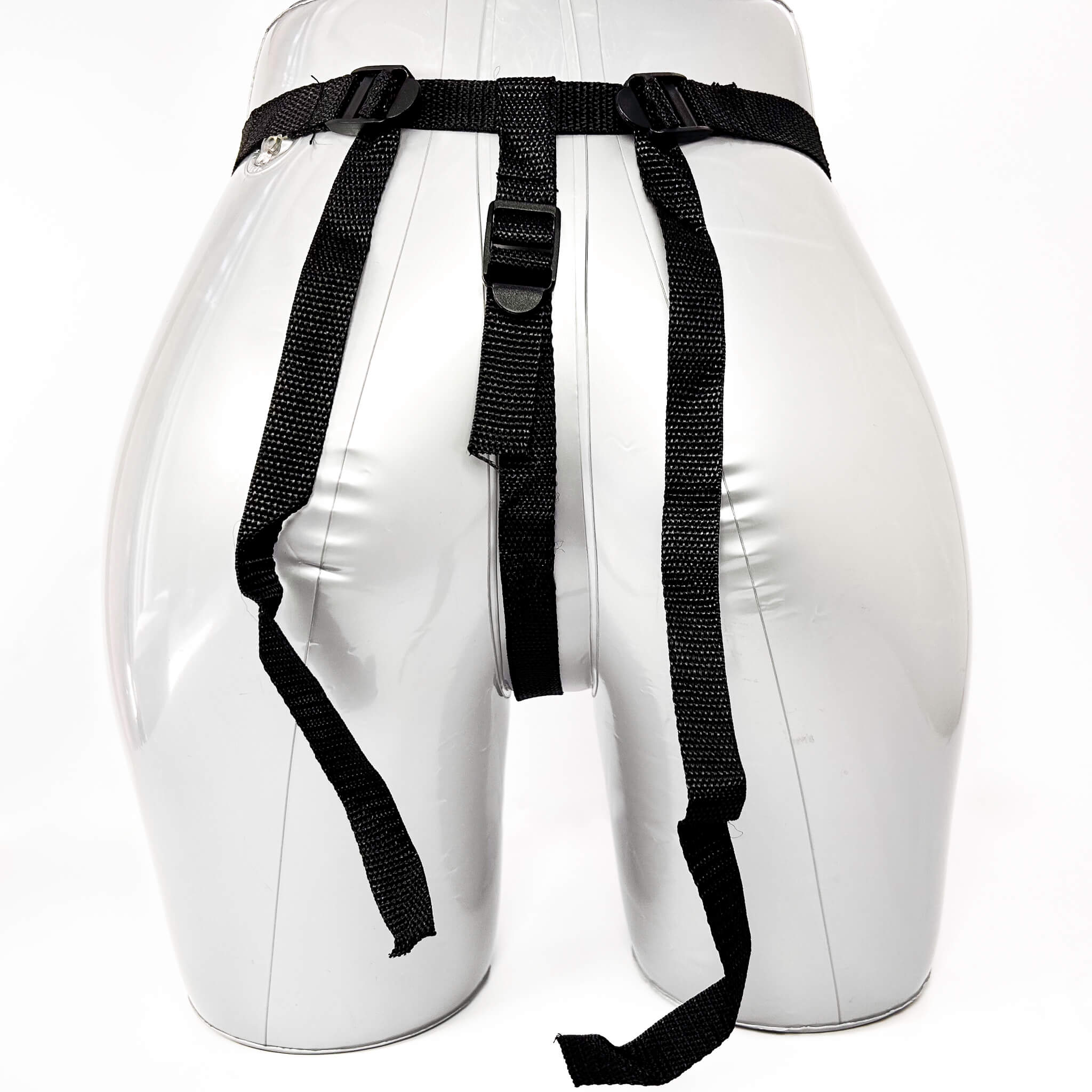 White dummy with black belts on a white background