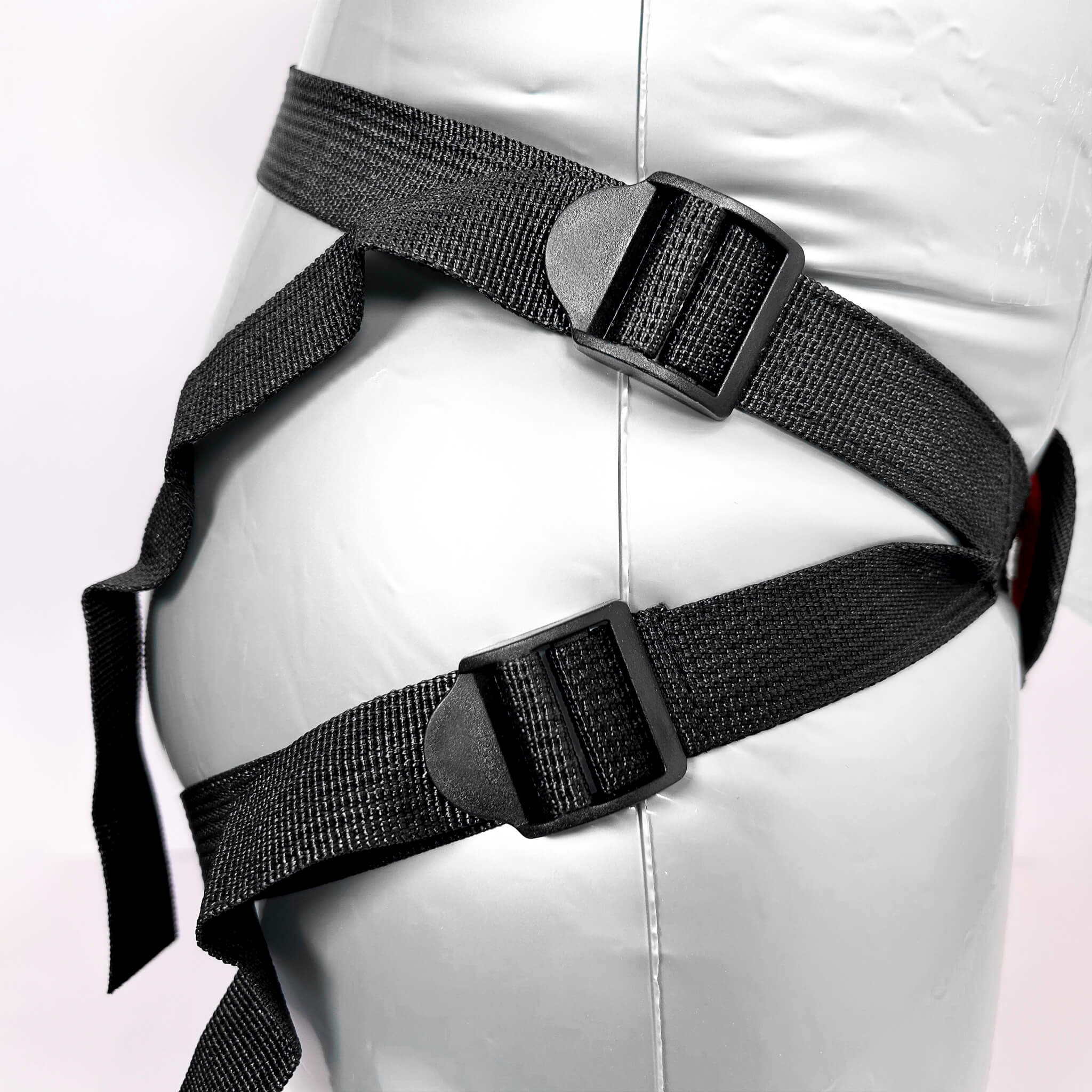 Black harness on a mannequin with a white background