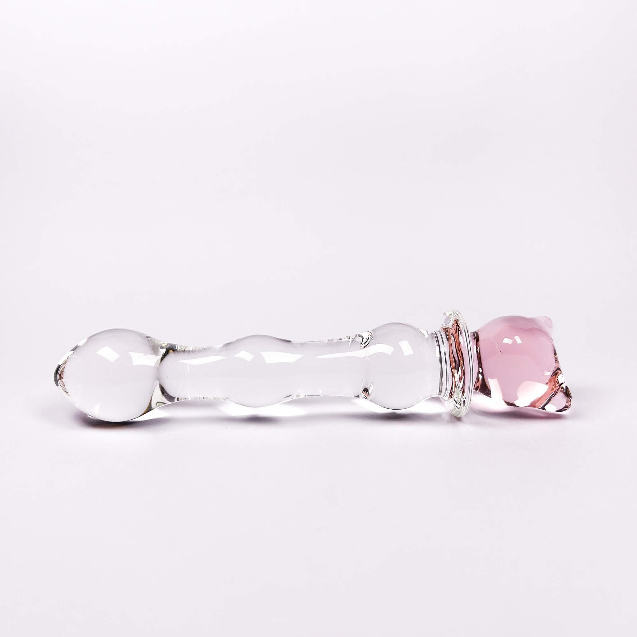 Glass anal dildo with pink and clear components on a white background