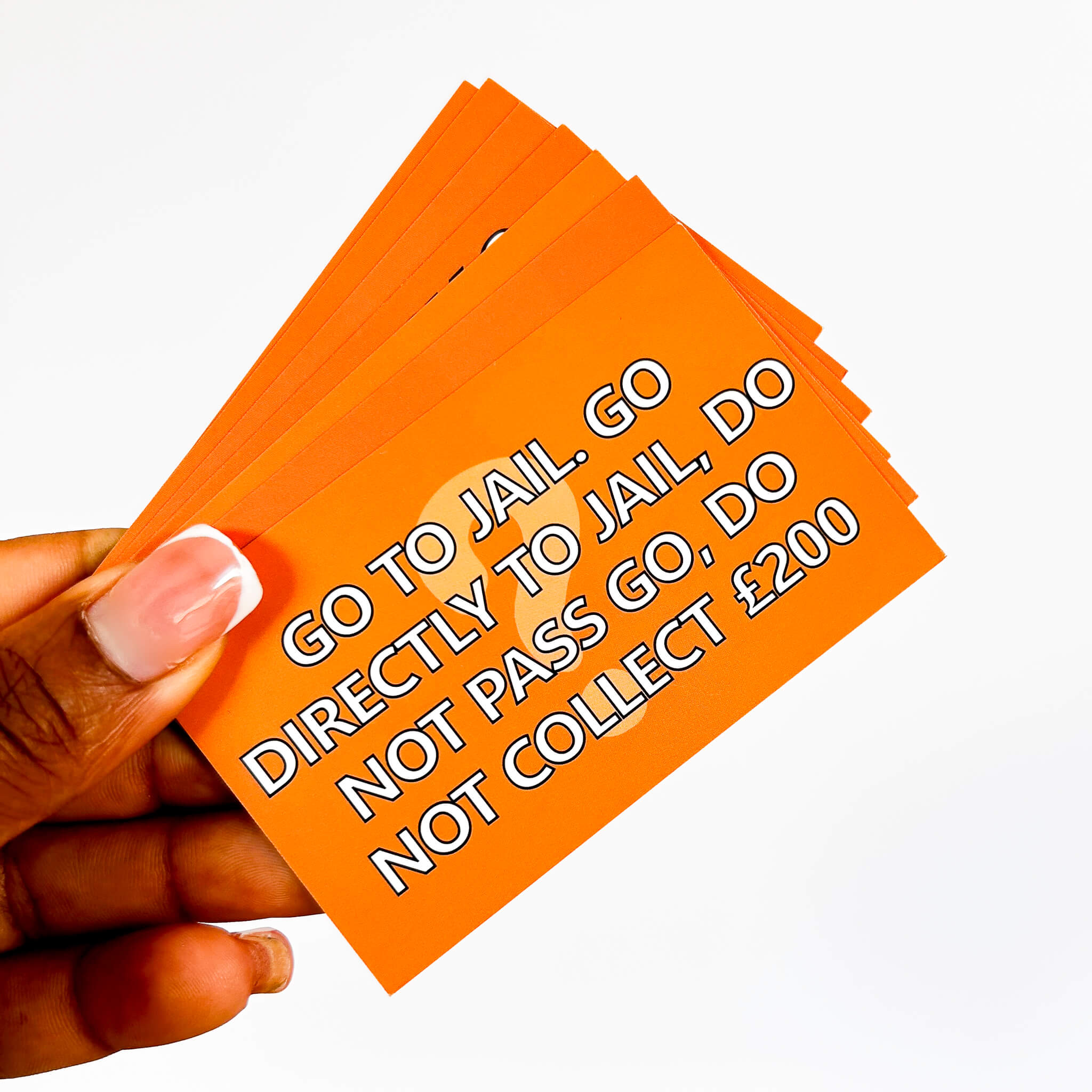Hand holding a stack of orange cards with text on a white background