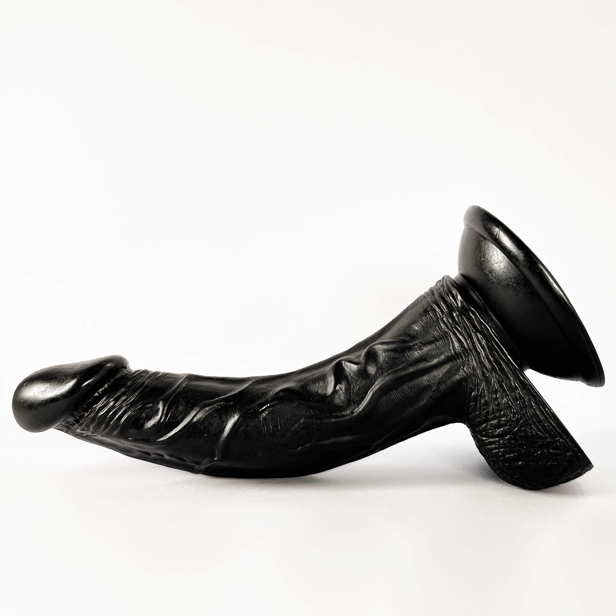 black curved dildo on a white background