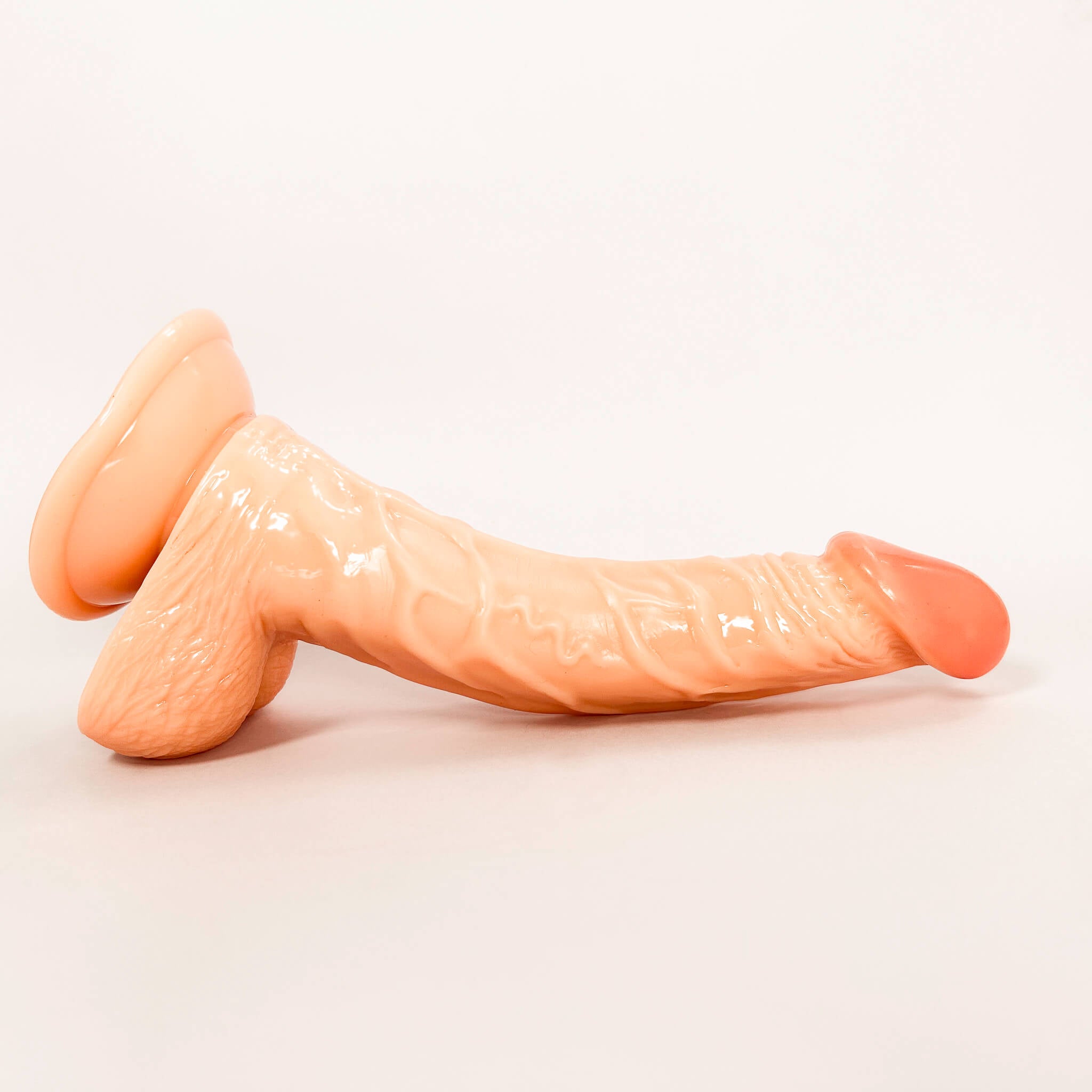 curved tip dildo on a white background