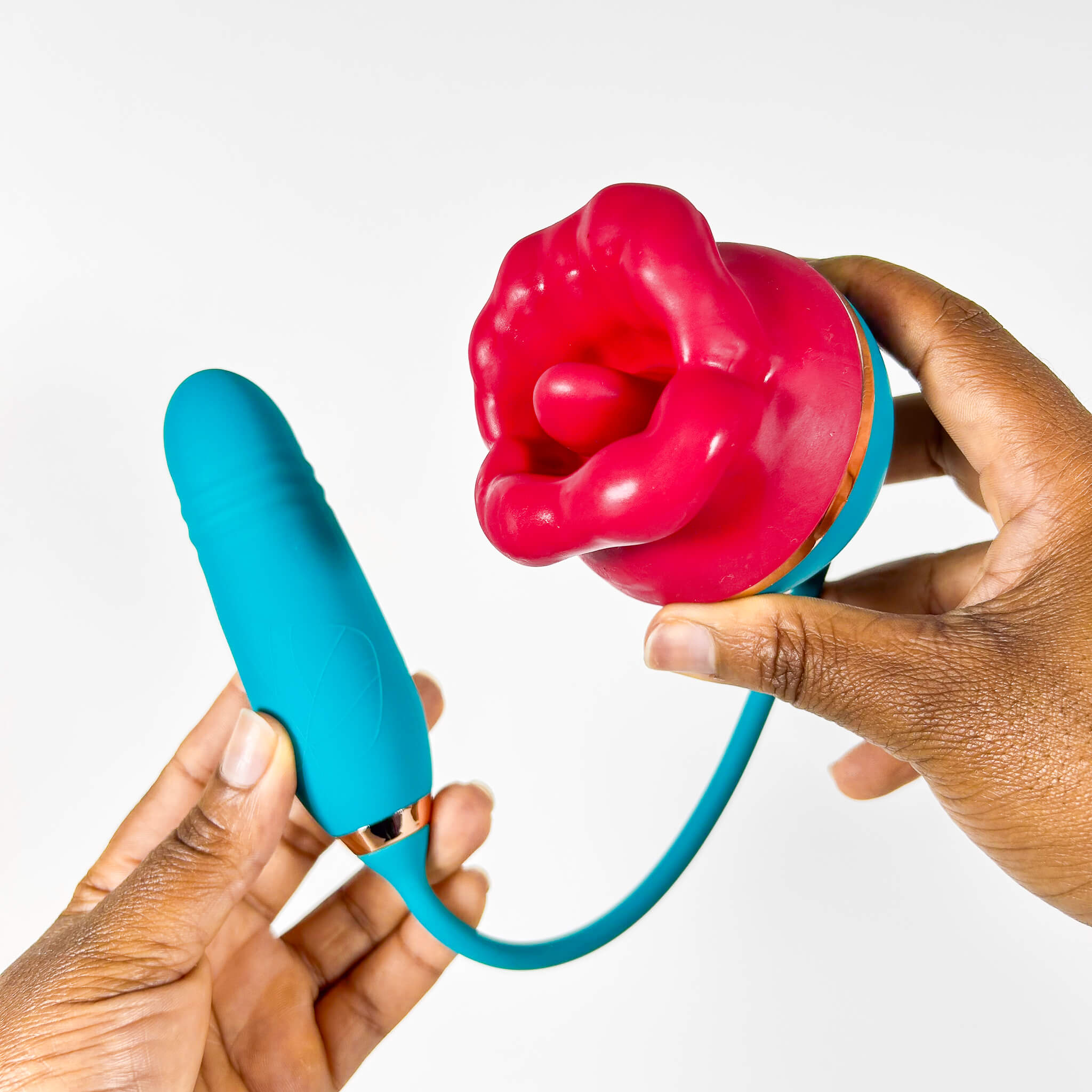 licking tongue vibrator held by hands against a white background