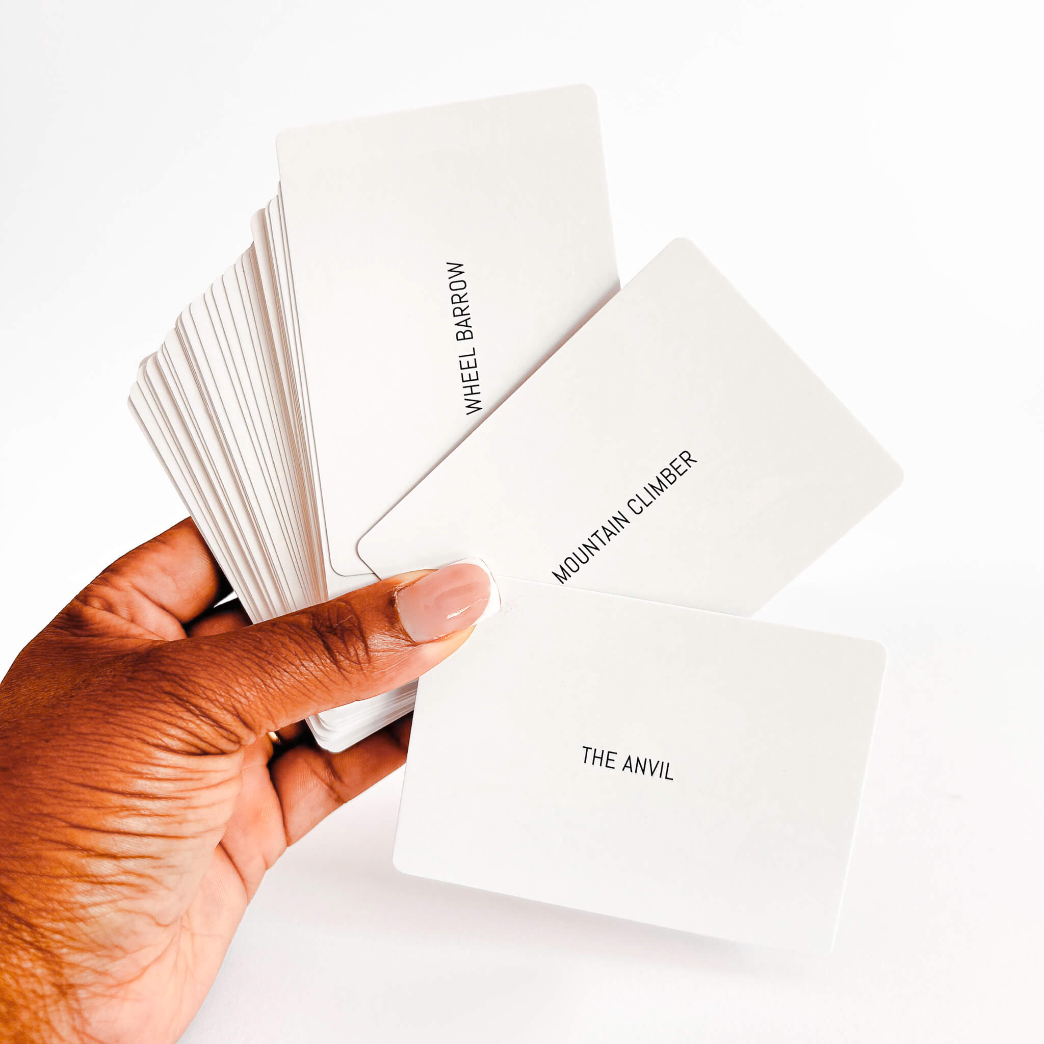 Hand holding a deck of sex position game with text on the back