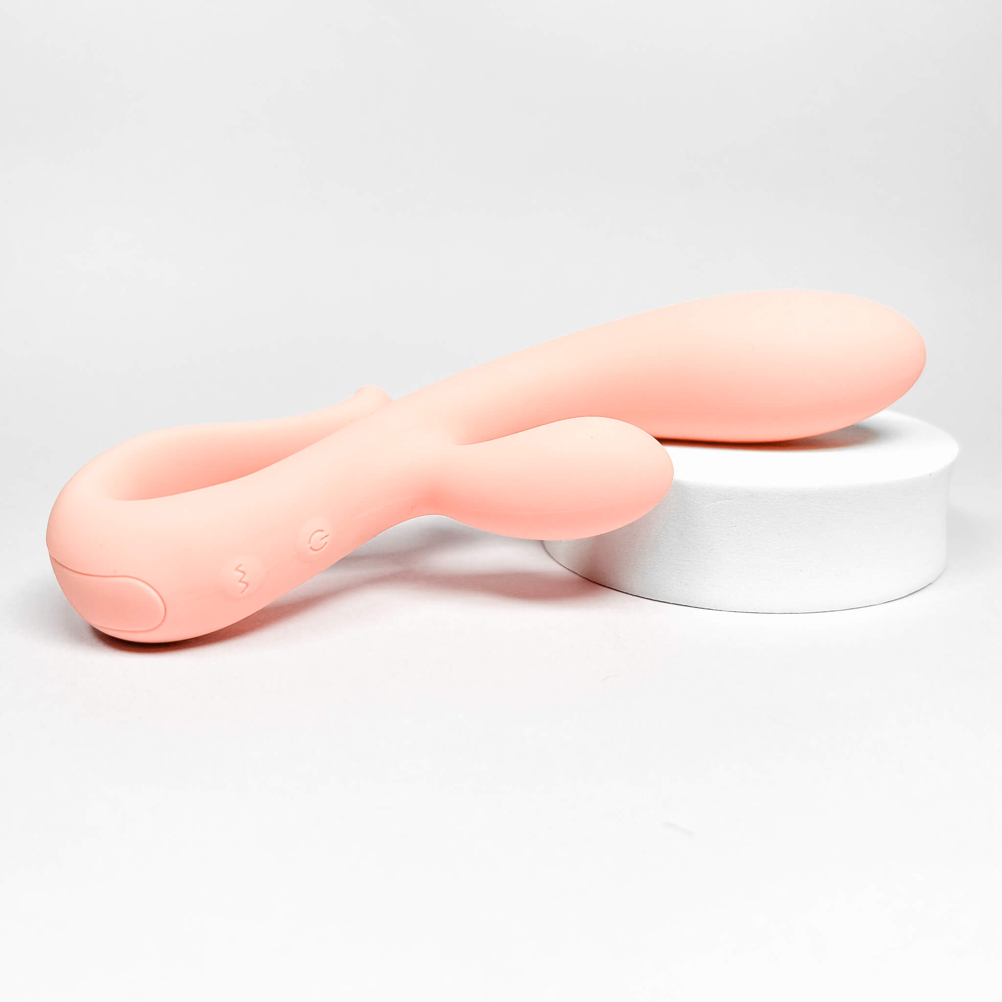 Pink silicone rabbit vibrator beginners on a light gray background