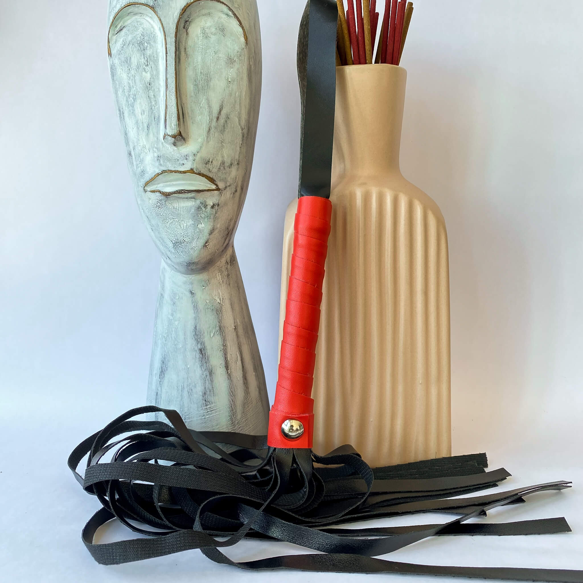 red and black leather whip