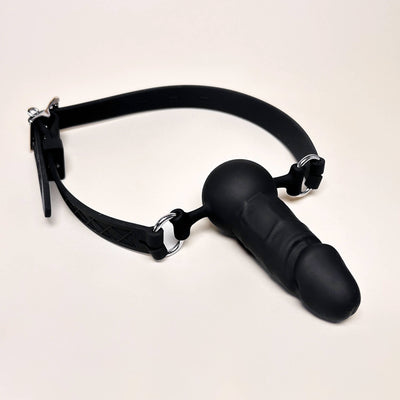Adjustable Silicone Dildo Mouth Gag with a matching collar on a beige background