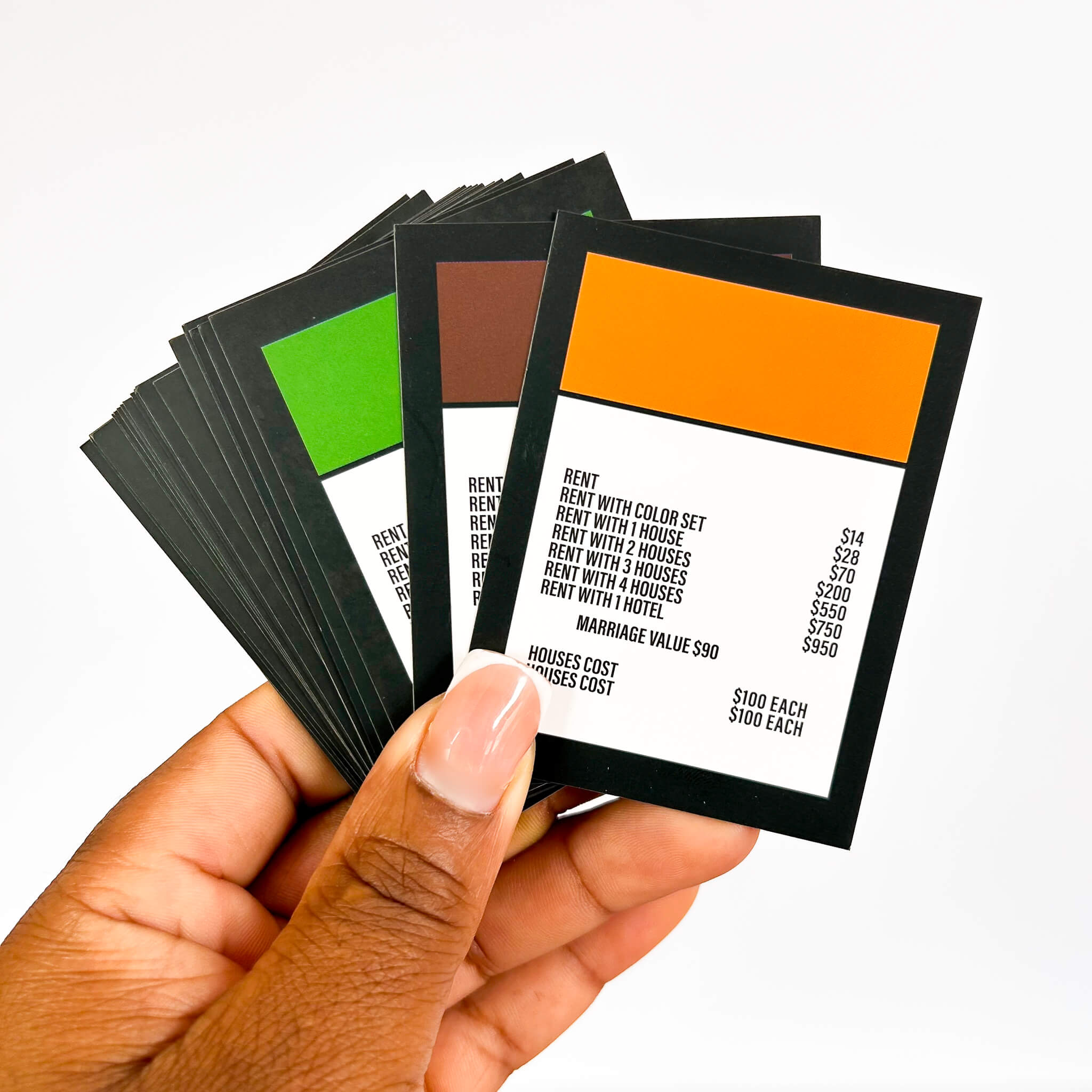 Hand holding a set of game cards with different colored backgrounds