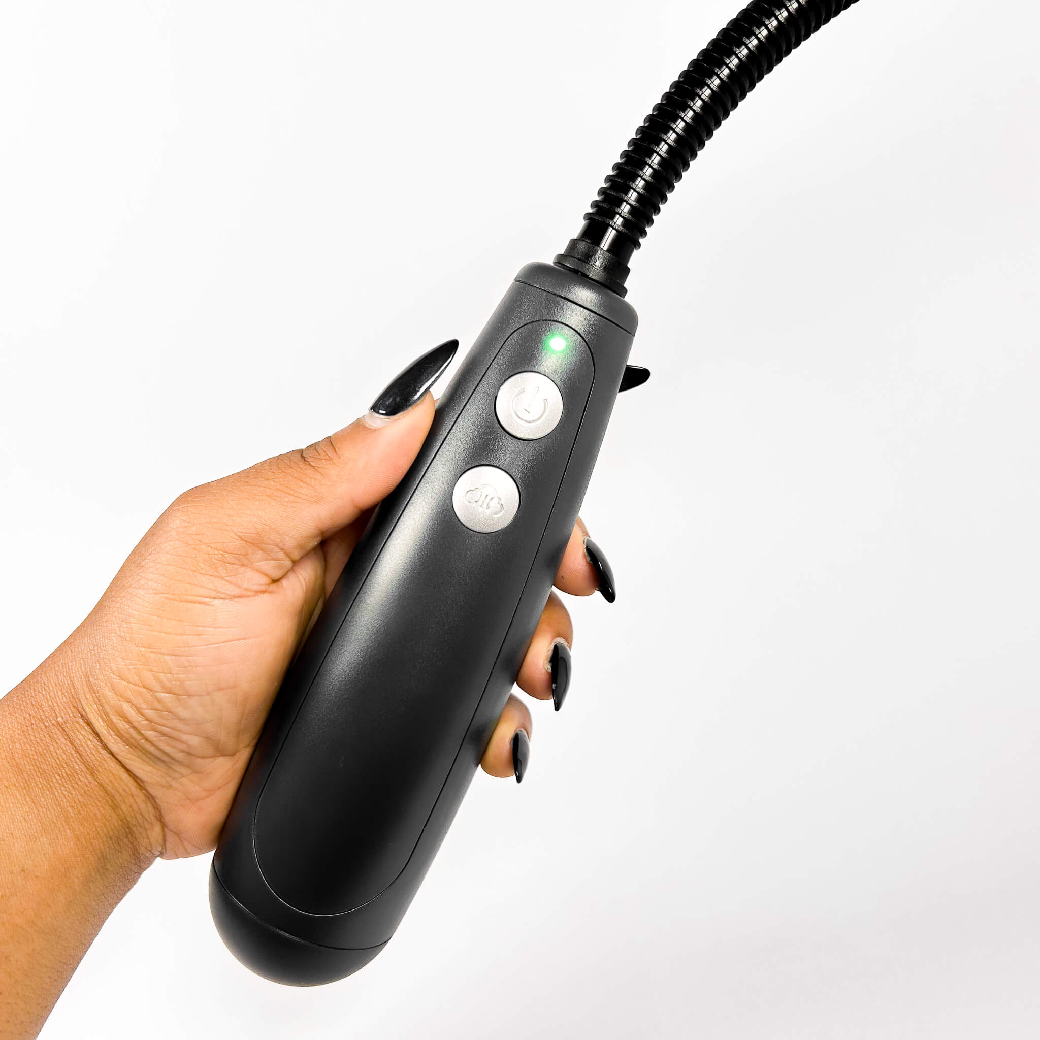 Hand holding a Automatic Penis Pump  with buttons on a white background