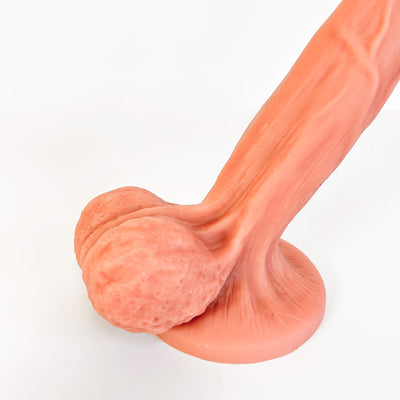 A realistic flesh-toned silicone adult novelty item with a textured, bulbous base and a long, muscular shaft, photographed on a clean white background.