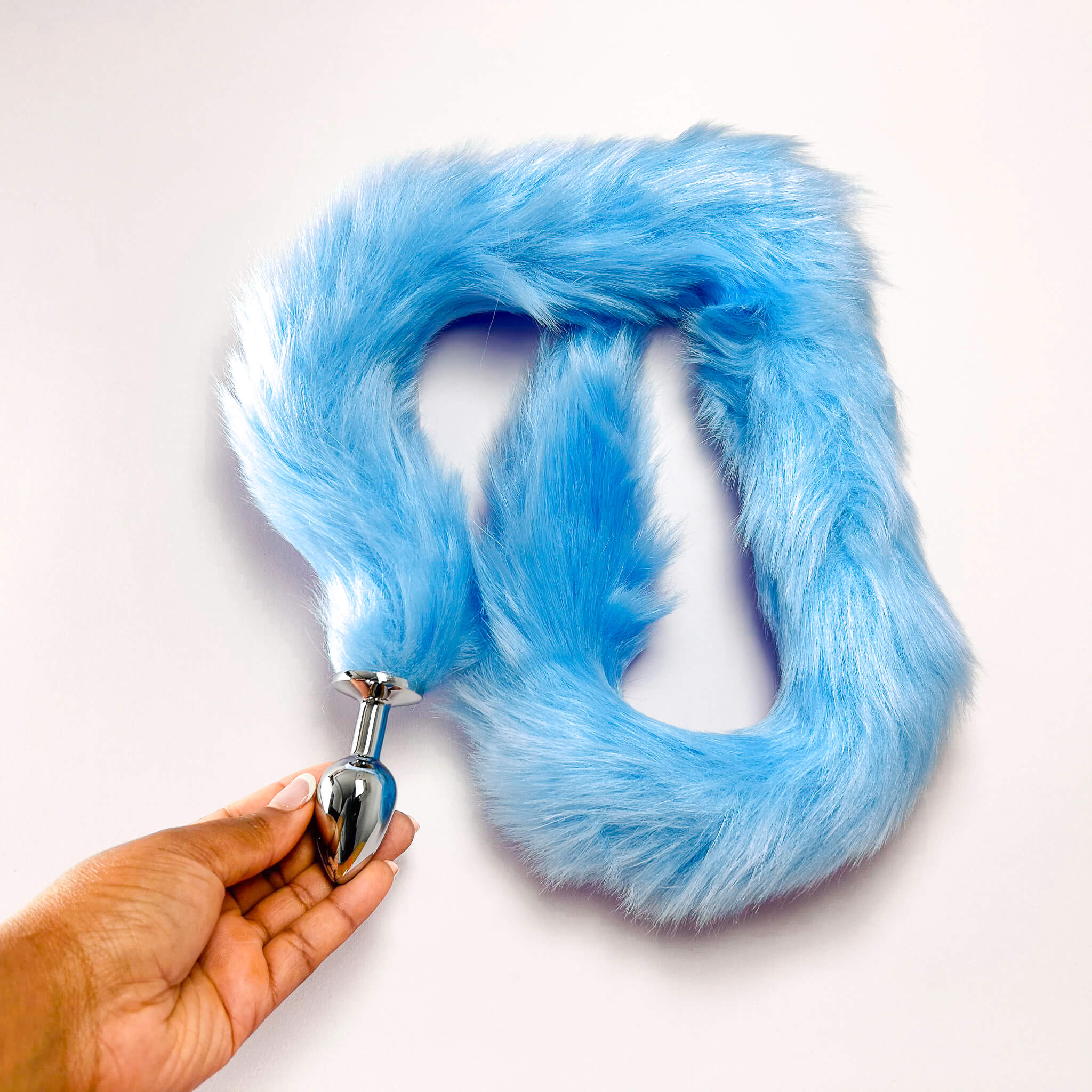 Blue 70cm Extra Long Tail With Metal Butt Plug held by a hand on a white background