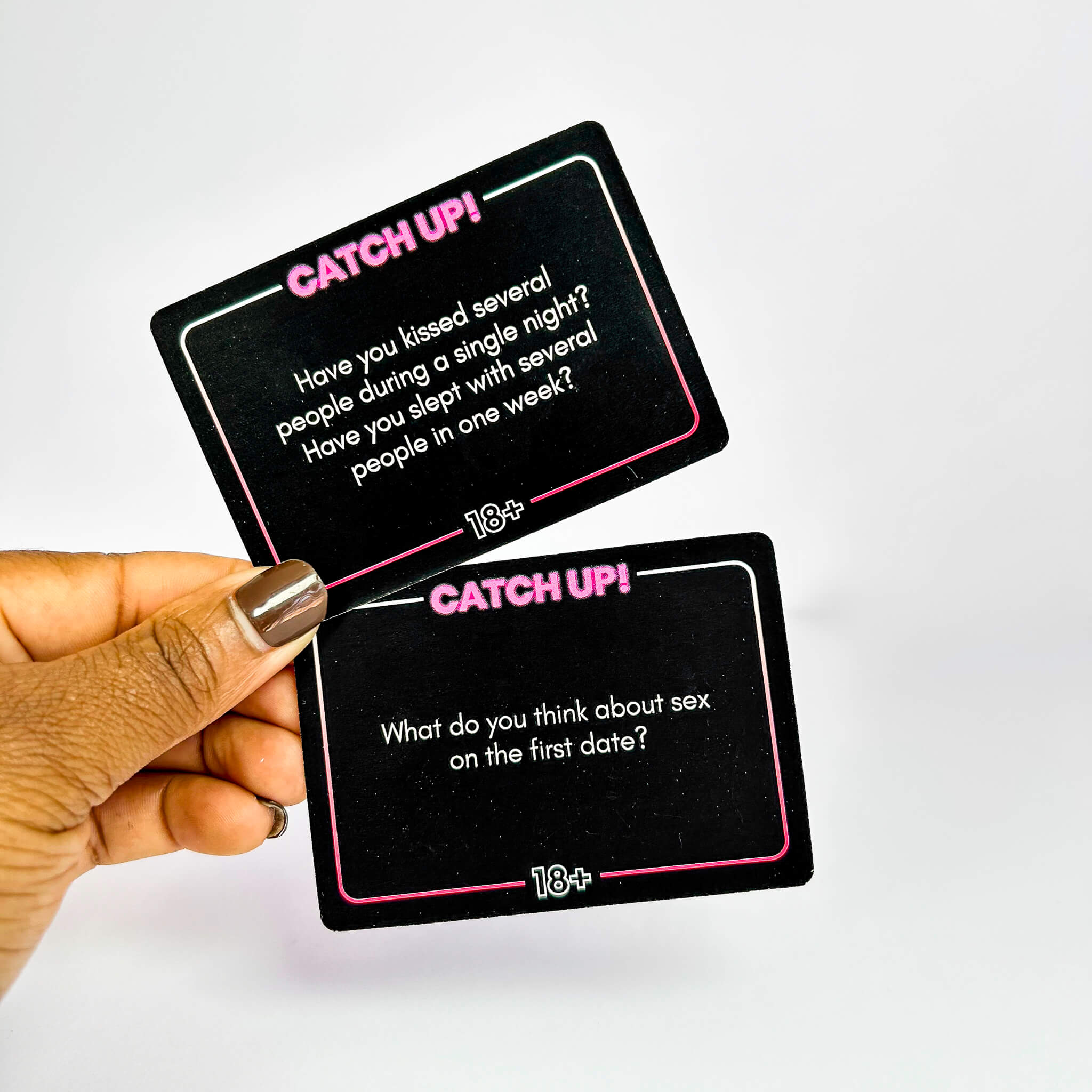 Two 'Catch Up!' cards held by a hand with a white background