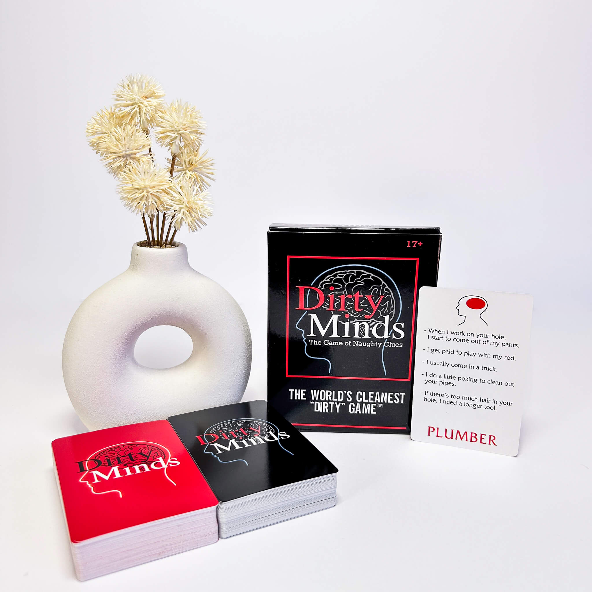 Card game 'Dirty Minds' with cards and packaging on a white background