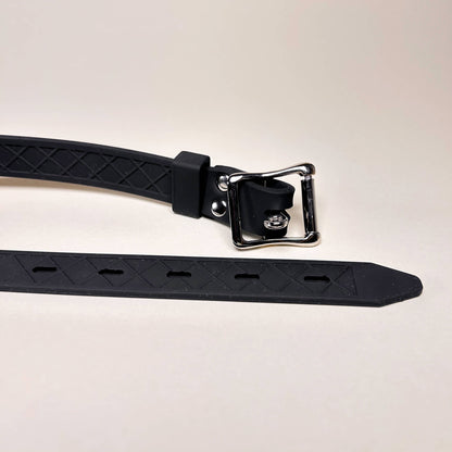 Double Dildo Gag with metal buckle on a light gray background