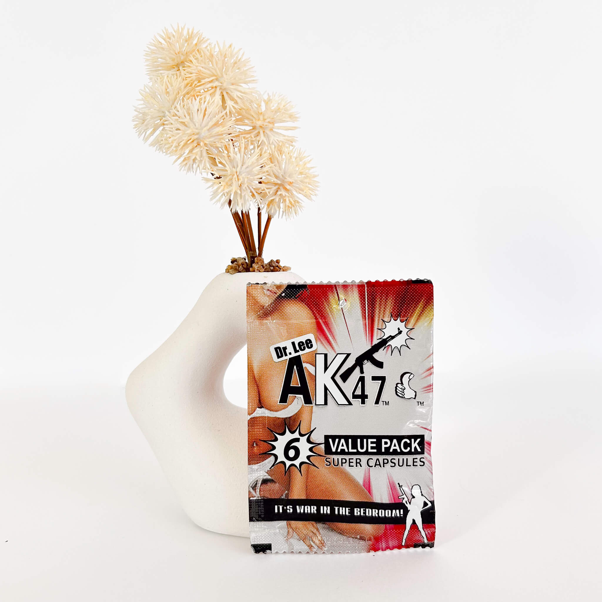 Dr. Lee AK47 value pack super capsules on a white background with decorative elements.