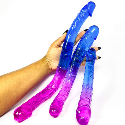 Purple and blue Dual Delight Double Sided Dildos held by a hand on a white background