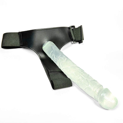 Glowing green strap on dildo with black leather harness on a white background