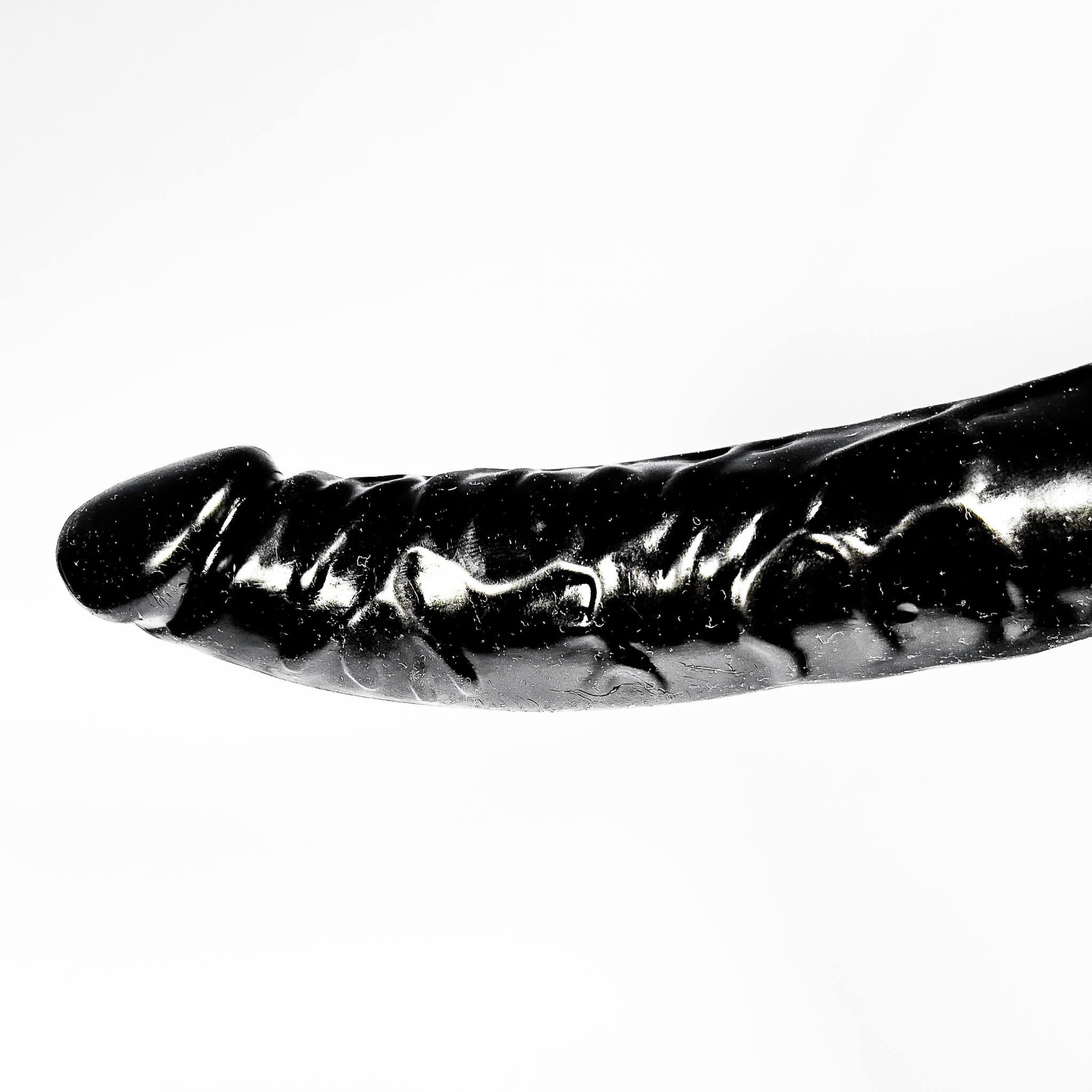 Black and white image of a dildo on a white background
