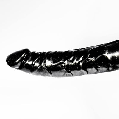 Black and white image of a dildo on a white background