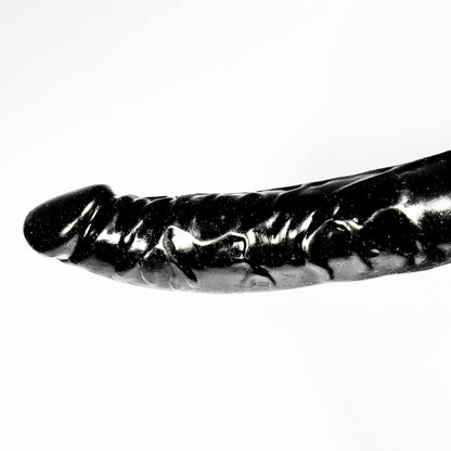 Black and white image of a dildo on a white background