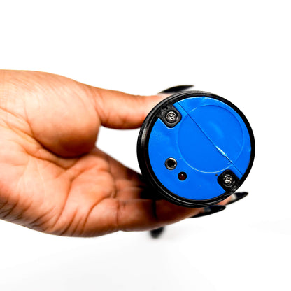 Hand holding a blue circular object with a black rim on a white background