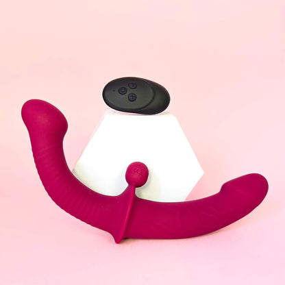 Remote Double Ended Dildo Vibrator With Clit Stimulator Ball with a pink body and white base on a pink background