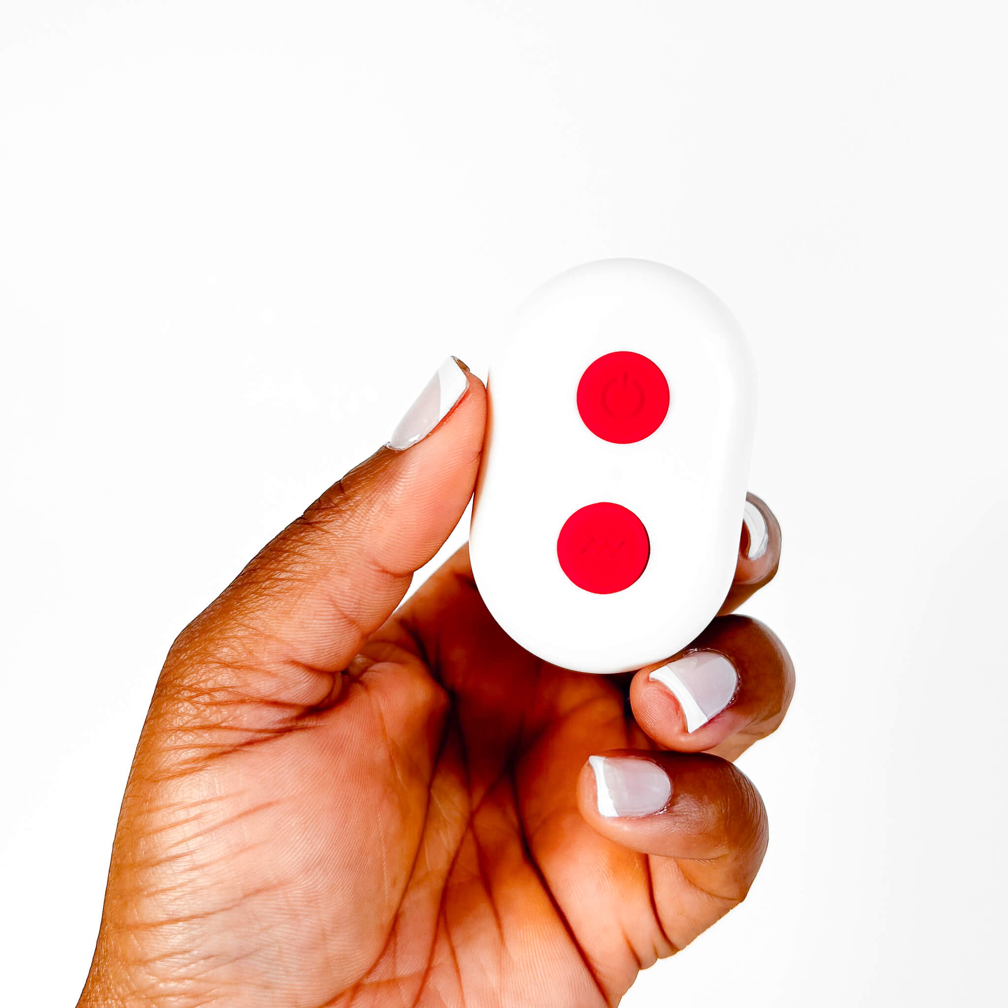 Hand holding a Rose Couples Cock Ring Remote on a white background