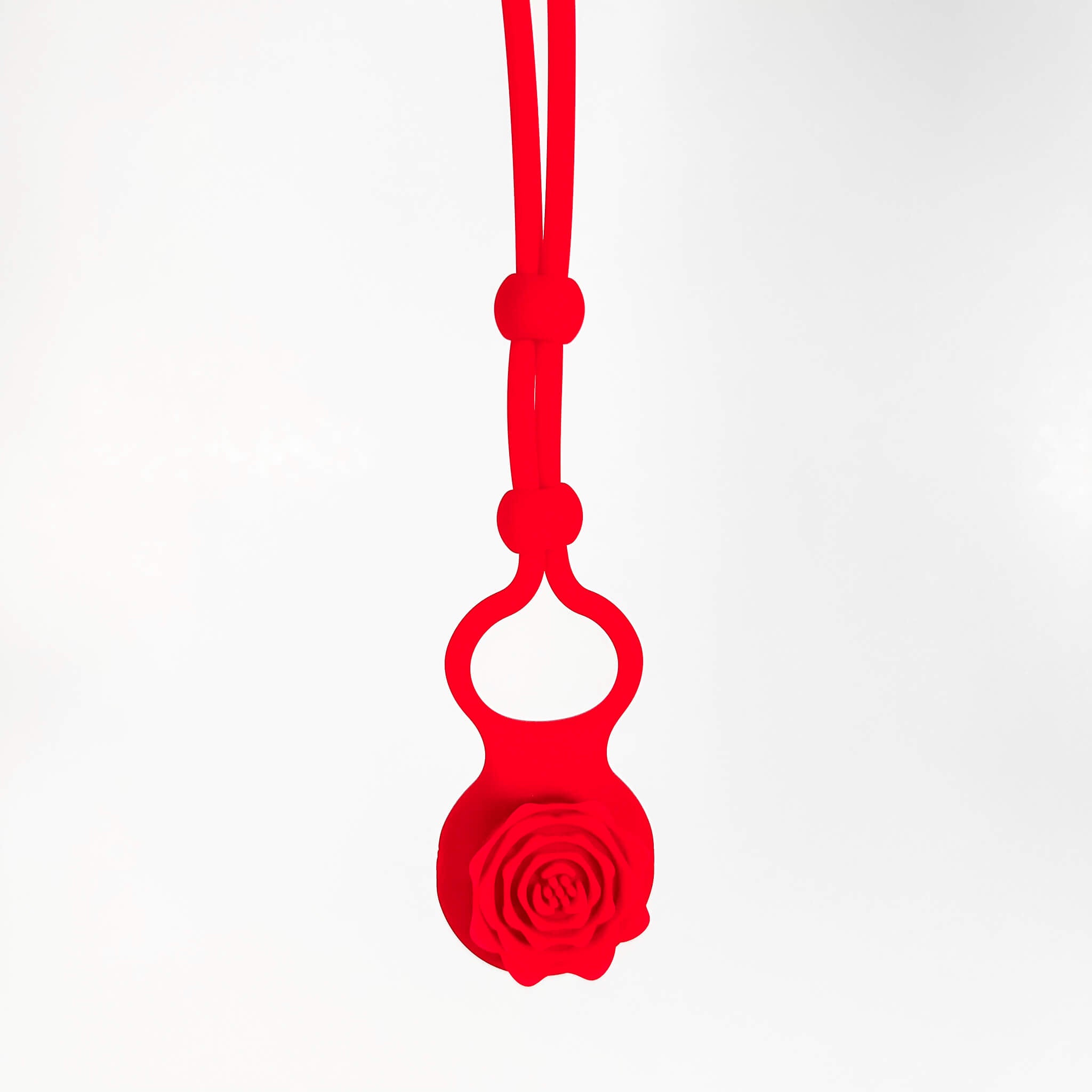 Red silicone adjustable cock ring with a rose design on a white background