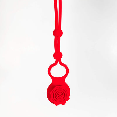 Red silicone adjustable cock ring with a rose design on a white background