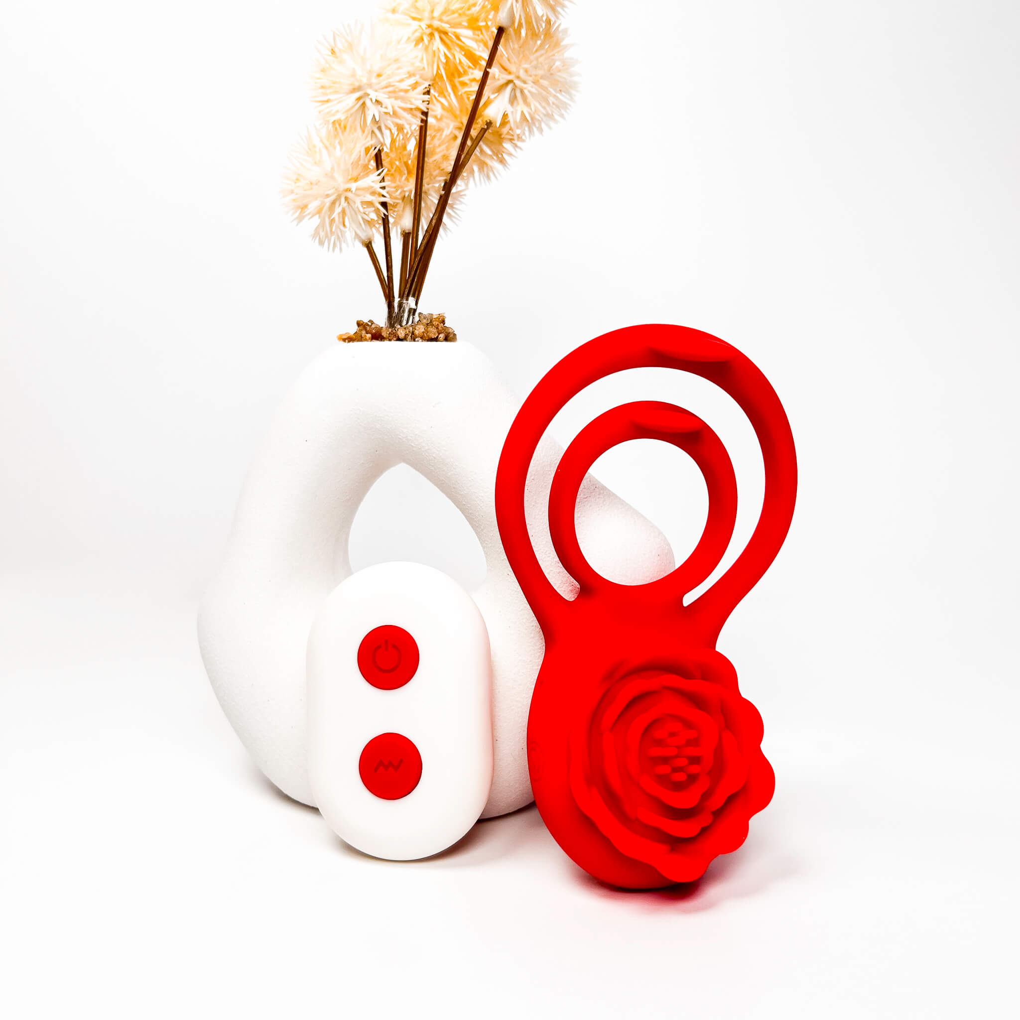 Red rose cock ring and plant pot on a white background
