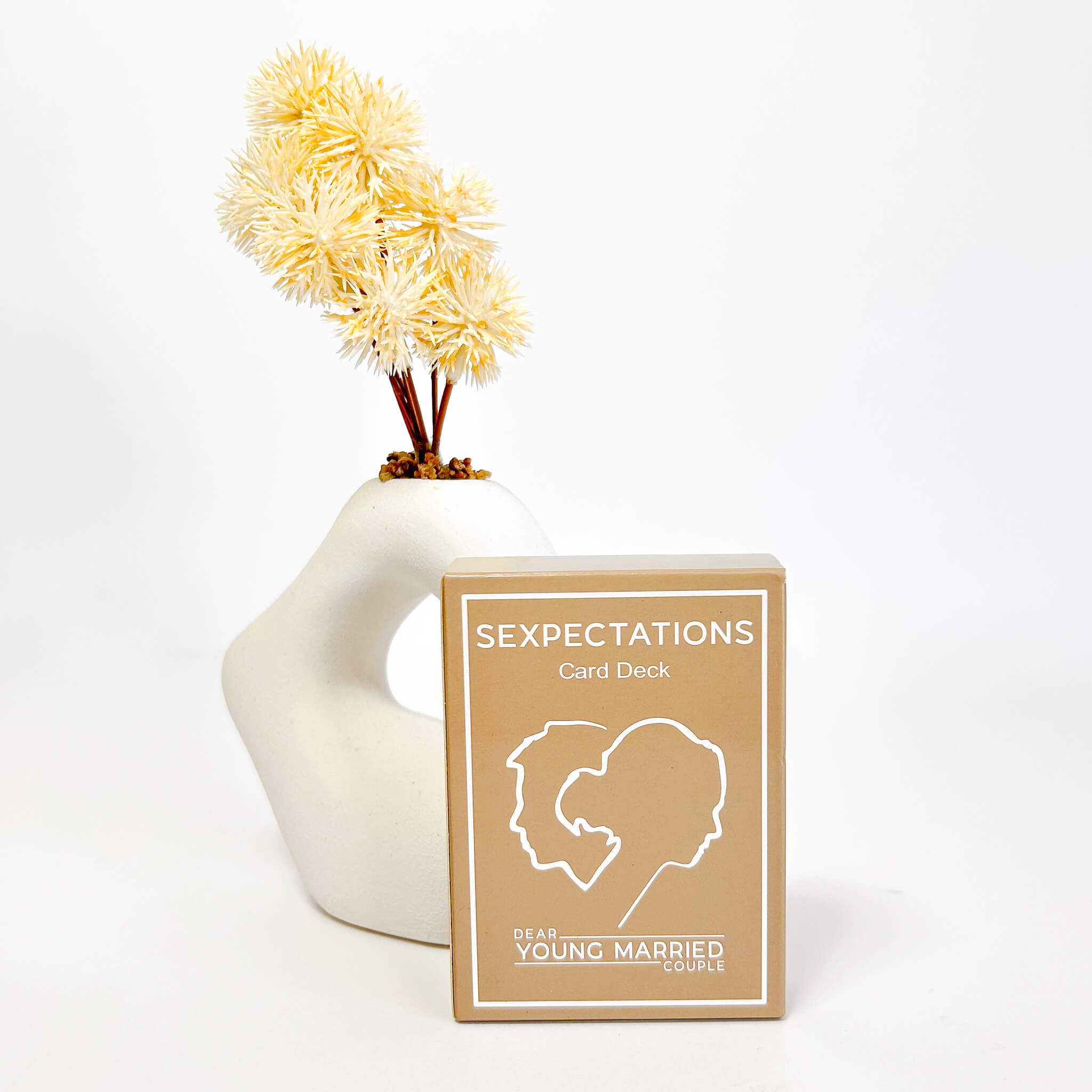 Card deck titled 'SEXPECTATIONS' by 'DEAR YOUNG MARRIED' with a decorative vase and flowers on a white background