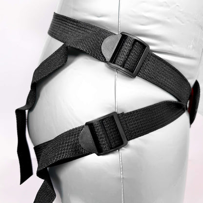 Black harness on a mannequin with a white background