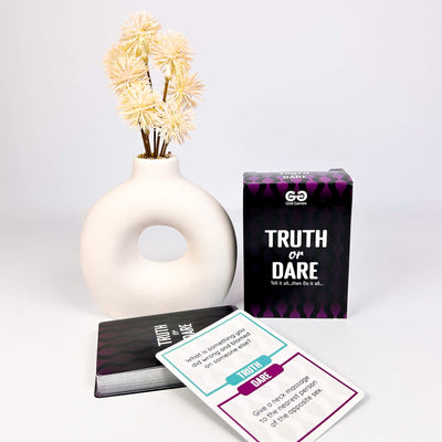 Truth or Dare Card Game for Adults with cards, a vase, and flowers on a white background