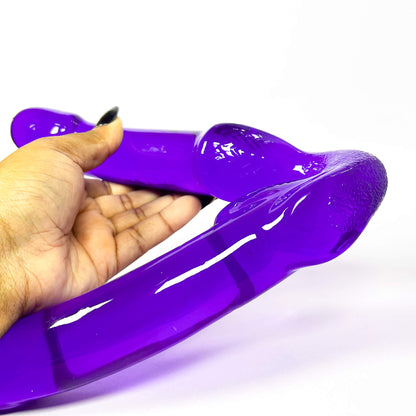U-Turn Double Sided Dildo held by a hand on a white background
