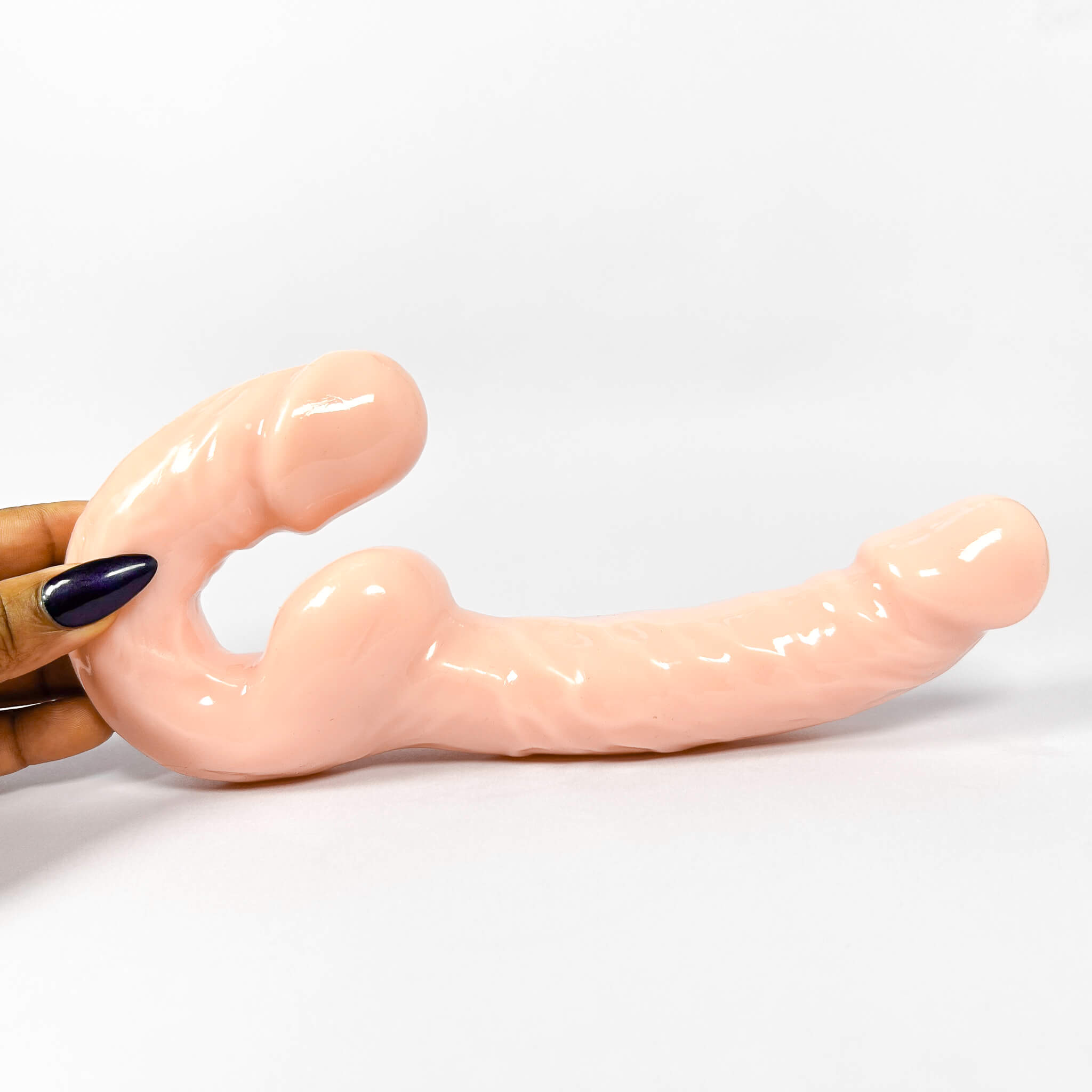 Ultra Realistic Strapless Double Ended Dildo (24cm/9.2inch) by a hand on a white background