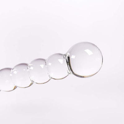 Clear glass beaded dildo on a white background
