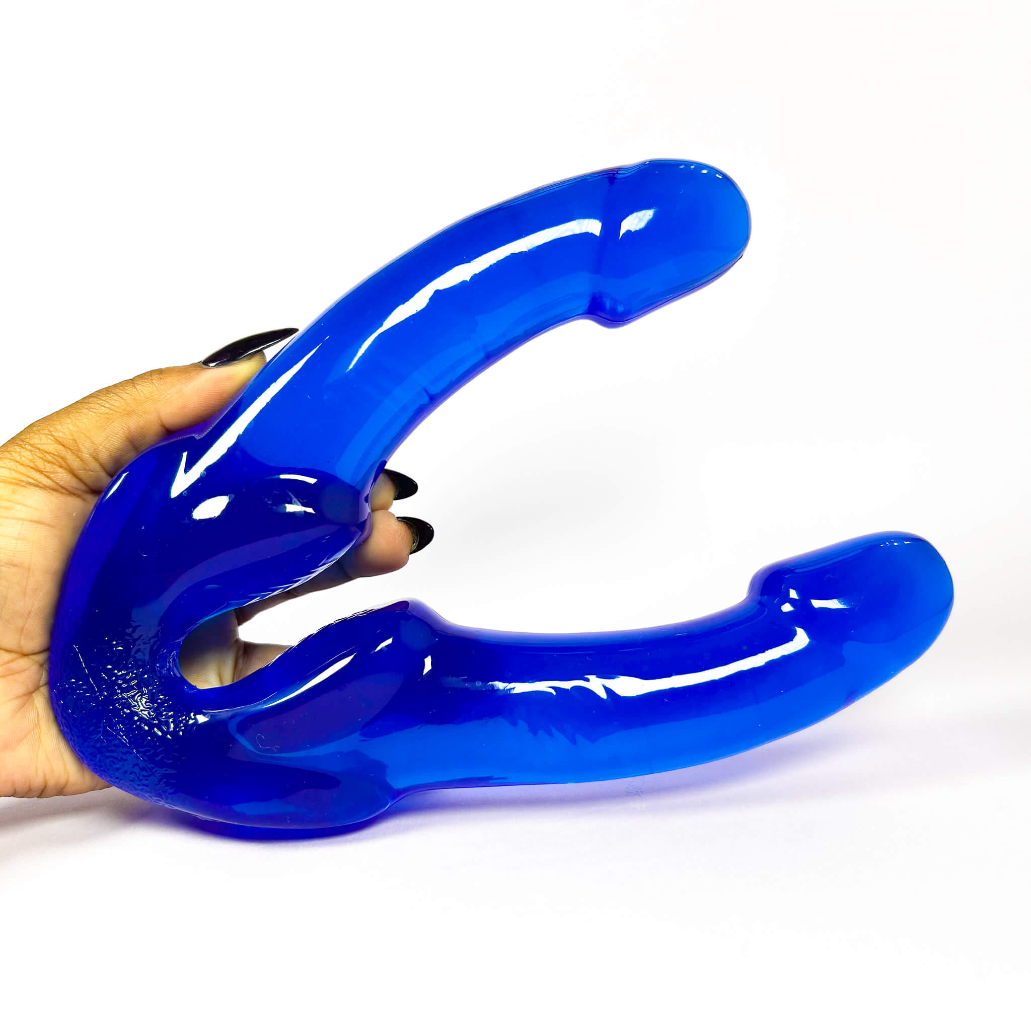 blue double dildo held by a hand on a white background