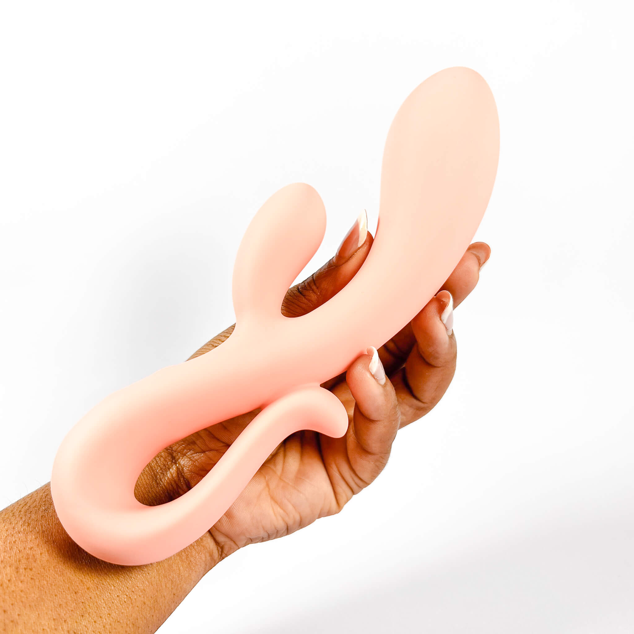 Hand holding a pink body-safe silicone rabbit against a white background