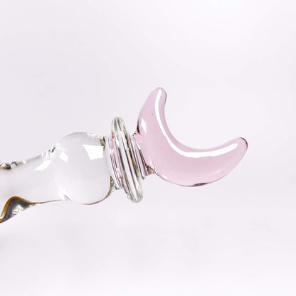 Pink crescent moon-shaped glass dildo on a white background